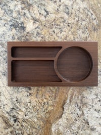 a wooden utensil holder on a marble countertop